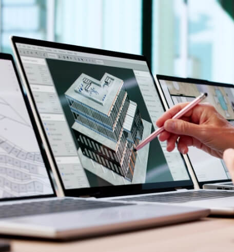 Architectural building model displayed on design software screens