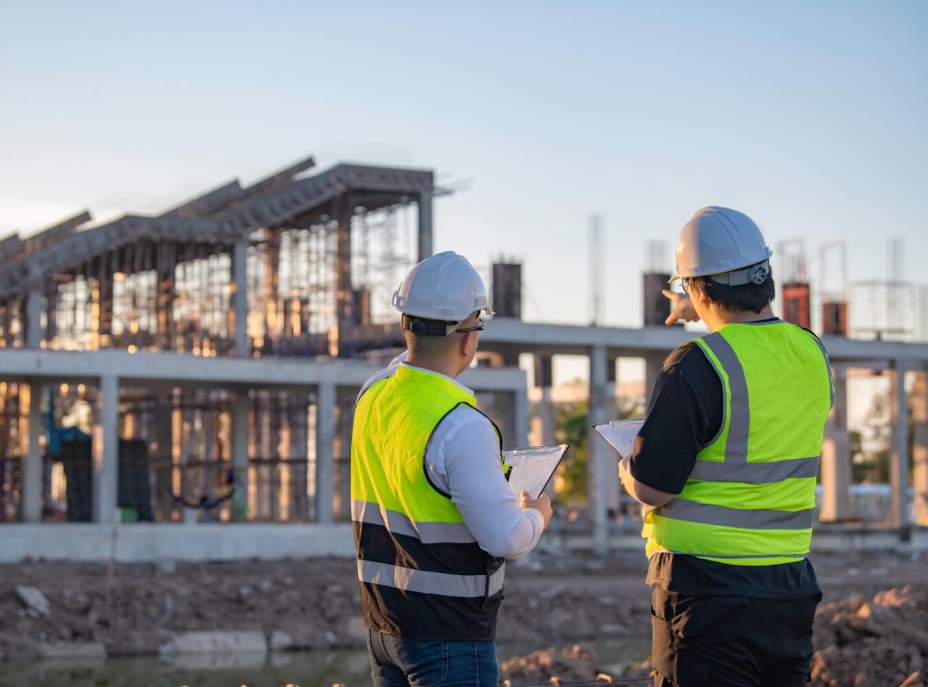 Construction managers reviewing progress at a building construction site