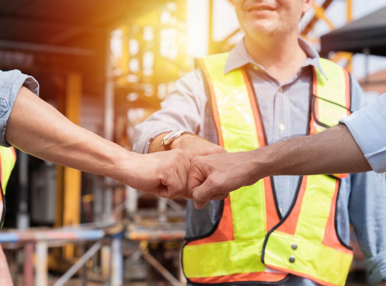 Construction team fist bumping at a jobsite
