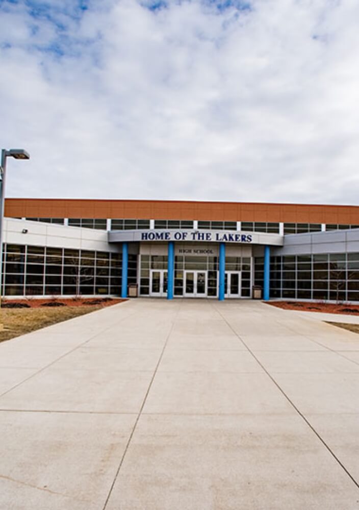 High school main entrance with large windows and front walkway