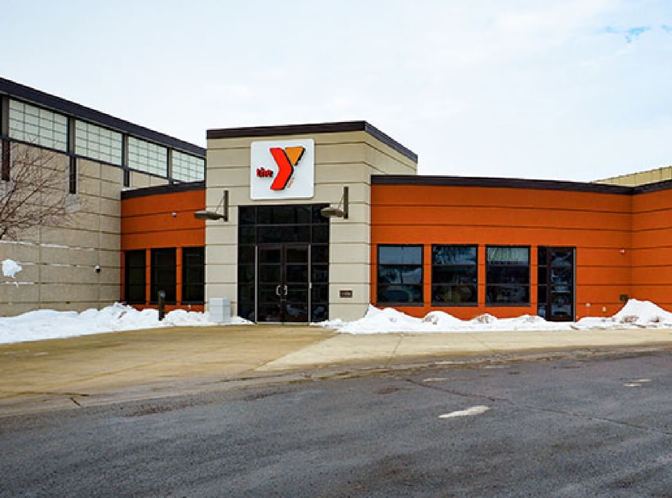 Exterior of the Marshall YMCA building with orange and tan facade