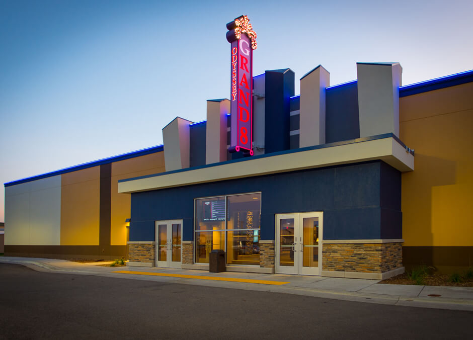 Odyssey Grand 8 Theatre exterior with illuminated sign and front entrance
