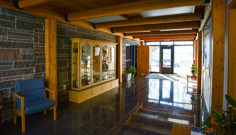 Ortonville St. John’s Catholic Church entry lobby with stone walls and wood beams