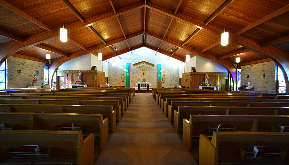 Ortonville St. John’s Catholic Church sanctuary with wood pews and vaulted ceiling