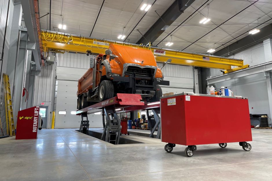 Public works maintenance facility service bay with truck lift and overhead crane