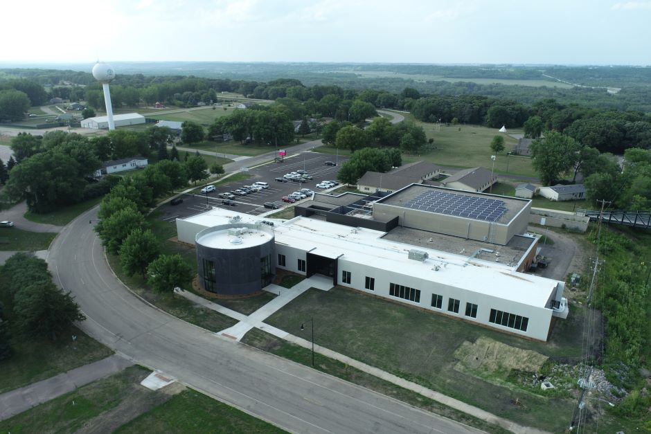 Aerial view of building with round architectural feature and surrounding streets