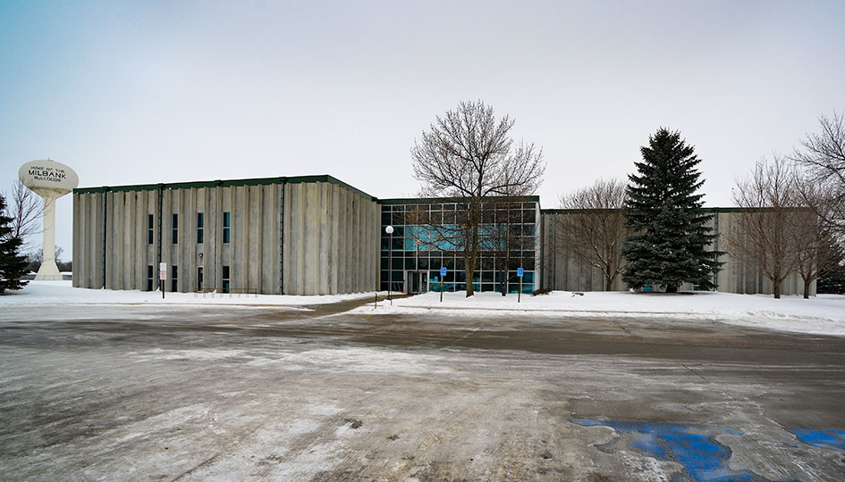 Unity Square exterior with glass entrance, snowy parking lot, and water tower