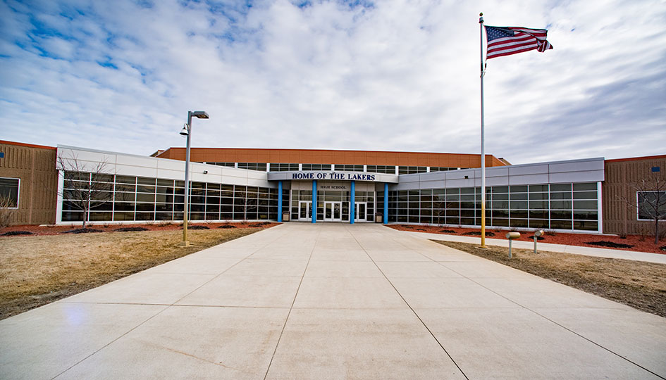 Exterior of Waverly-Winsted High School with front entrance and flagpole