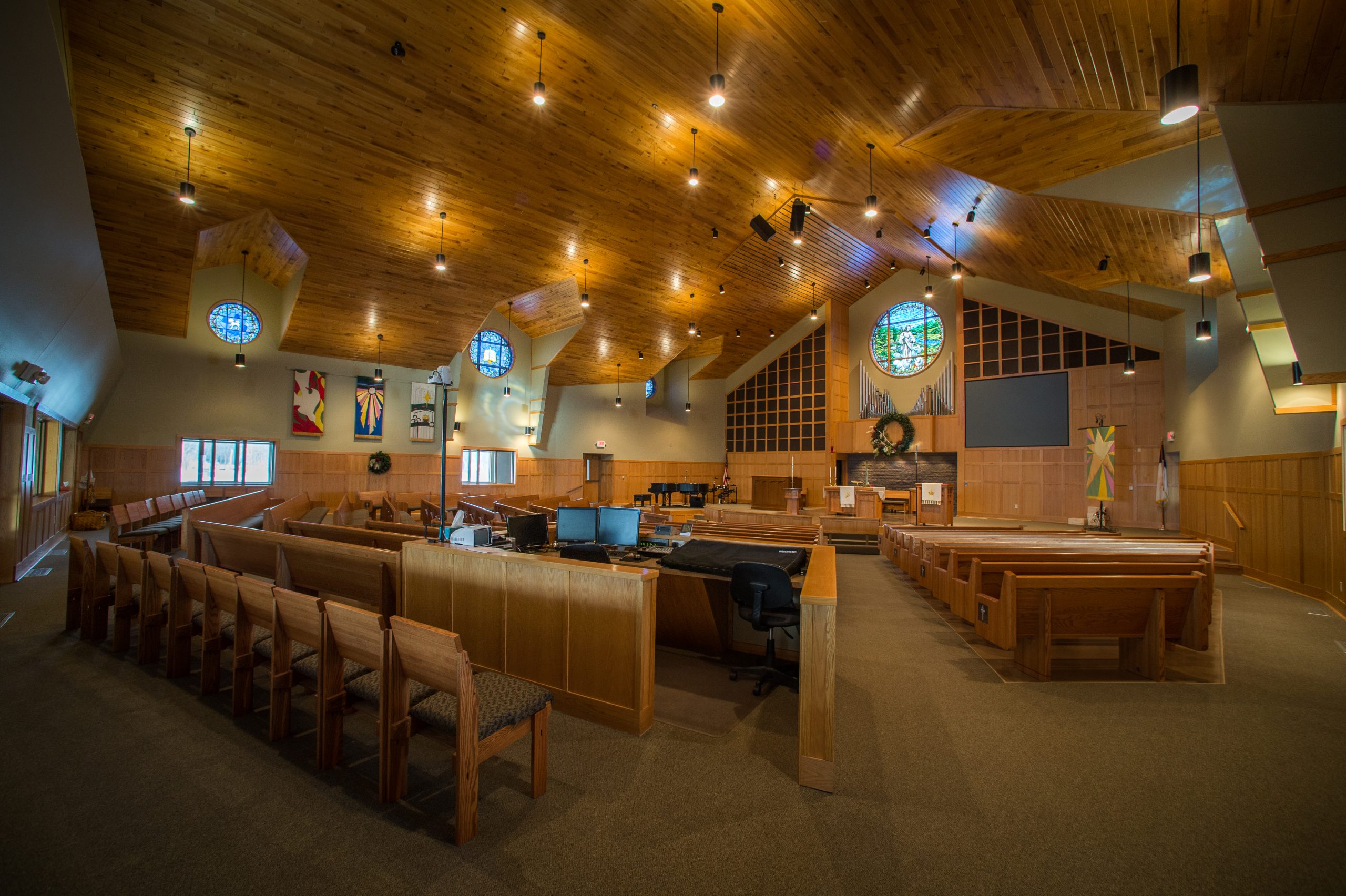 American Lutheran Church worship space with wood ceiling, pews, and chancel area