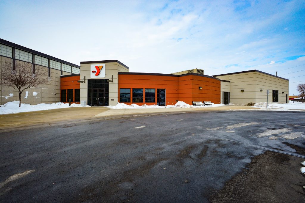 Exterior of the Marshall YMCA building with orange and tan facade