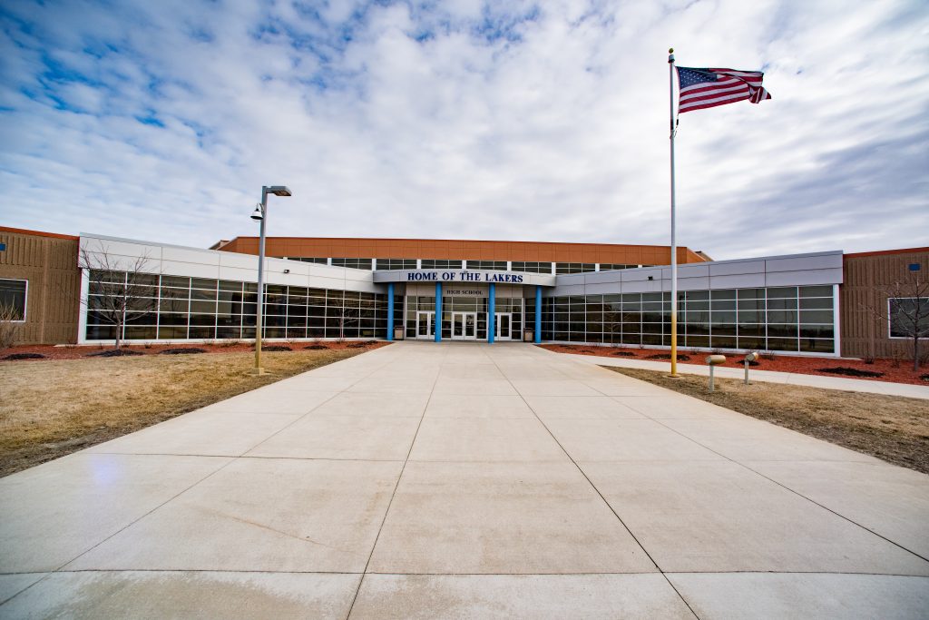 Exterior of Waverly-Winsted High School with front entrance and flagpole